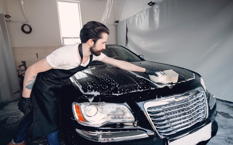 man-washing-his-car-garage